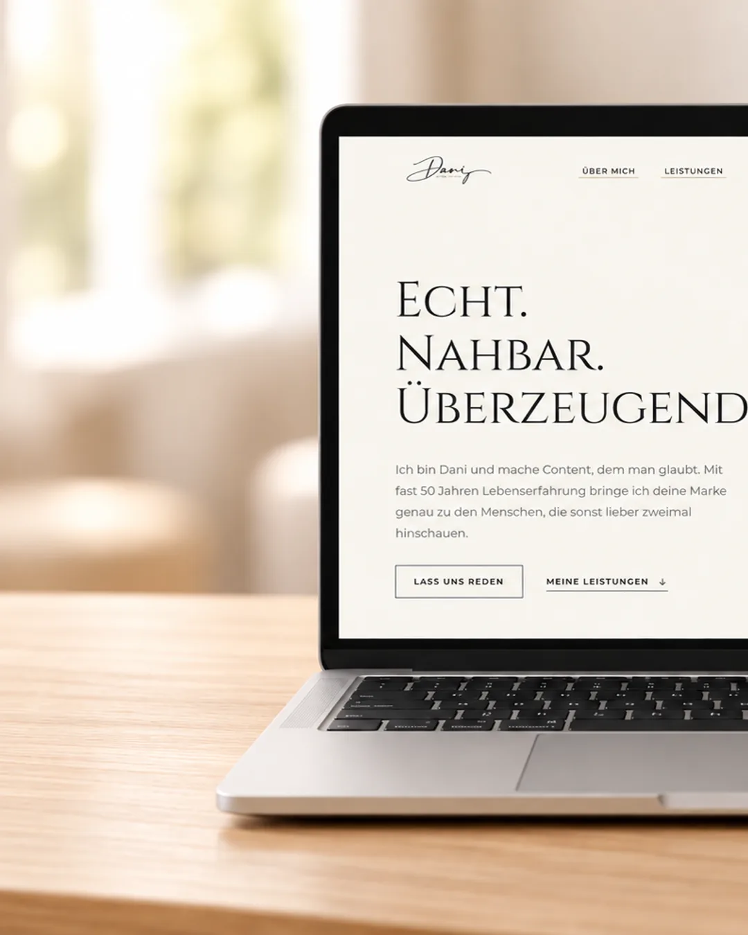 The home page on a laptop with the headline “Echt. Nahbar. Überzeugend.” and a portrait of Daniela